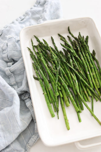 Roasted asparagus in a white dish.