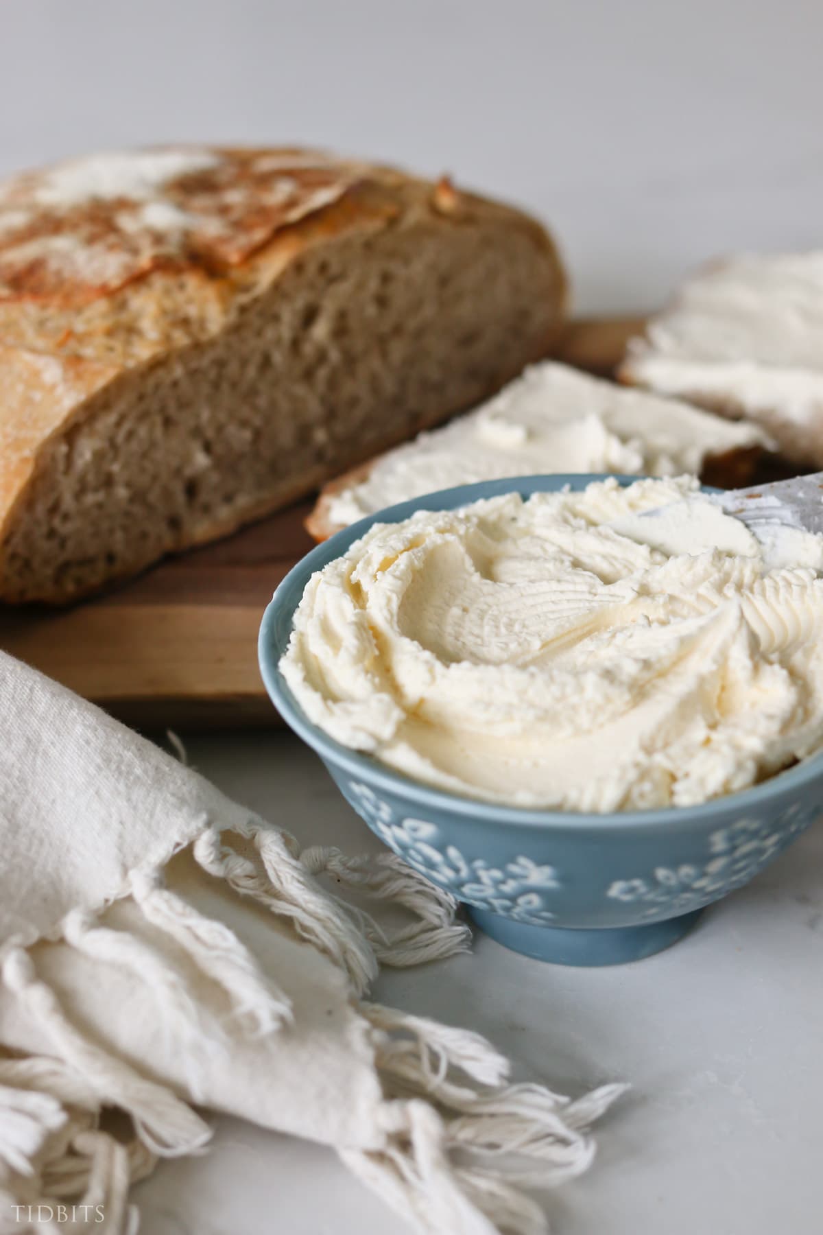 Close up bowl of homemade raw milk cream cheese and homemade bread
