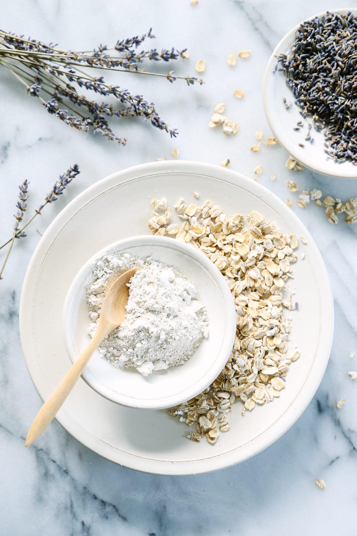 A bowl of oatmeal and powdered lavender cleansing grains