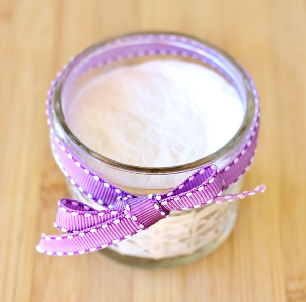 Mason jar of lavender baking soda air freshener tied with a purple ribbon