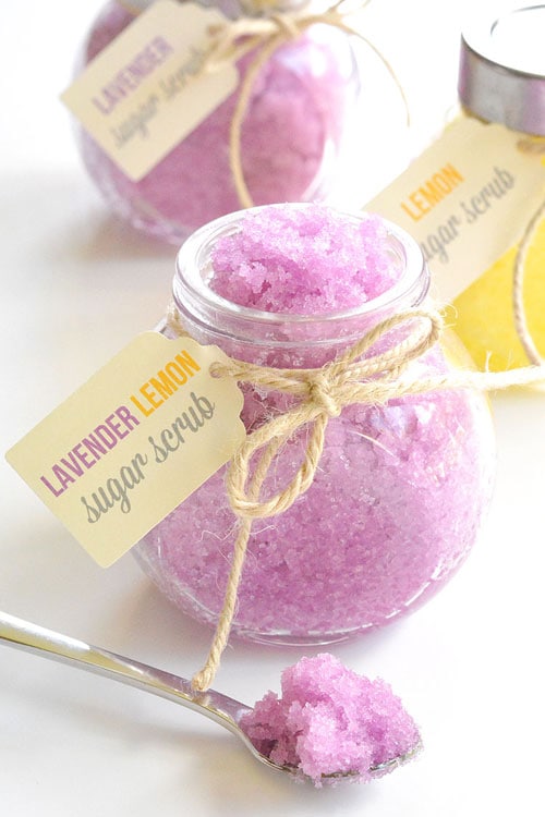 Glass jars filled with purple lavender and lemon sugar scrub