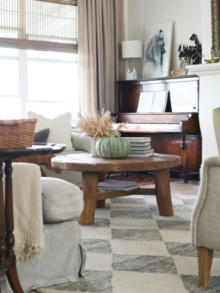 A living room decorated for fall with neutral pillow and throw blankets
