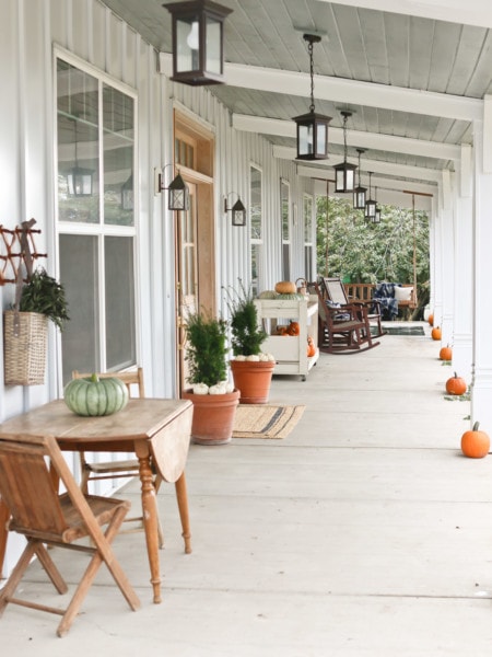 A view of a front porch decorated for fall