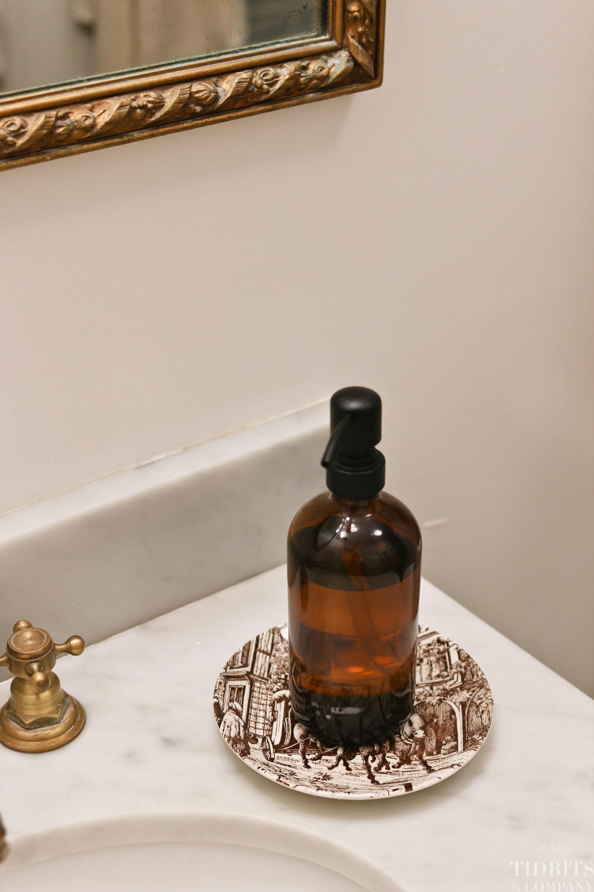 An amber glass bottle on a decorative plate