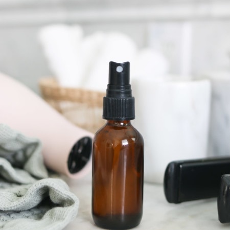 An amber spray bottle with homemade natural heat protectant spray for hair