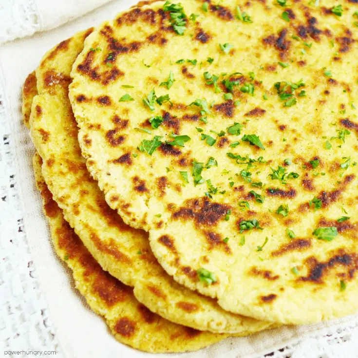 Naan made from chickpea flour is sprinkled with herbs