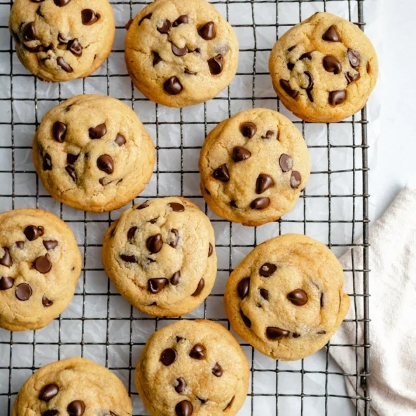 Chickpea flour chocolate chip cookies sit on a wire cooling rack