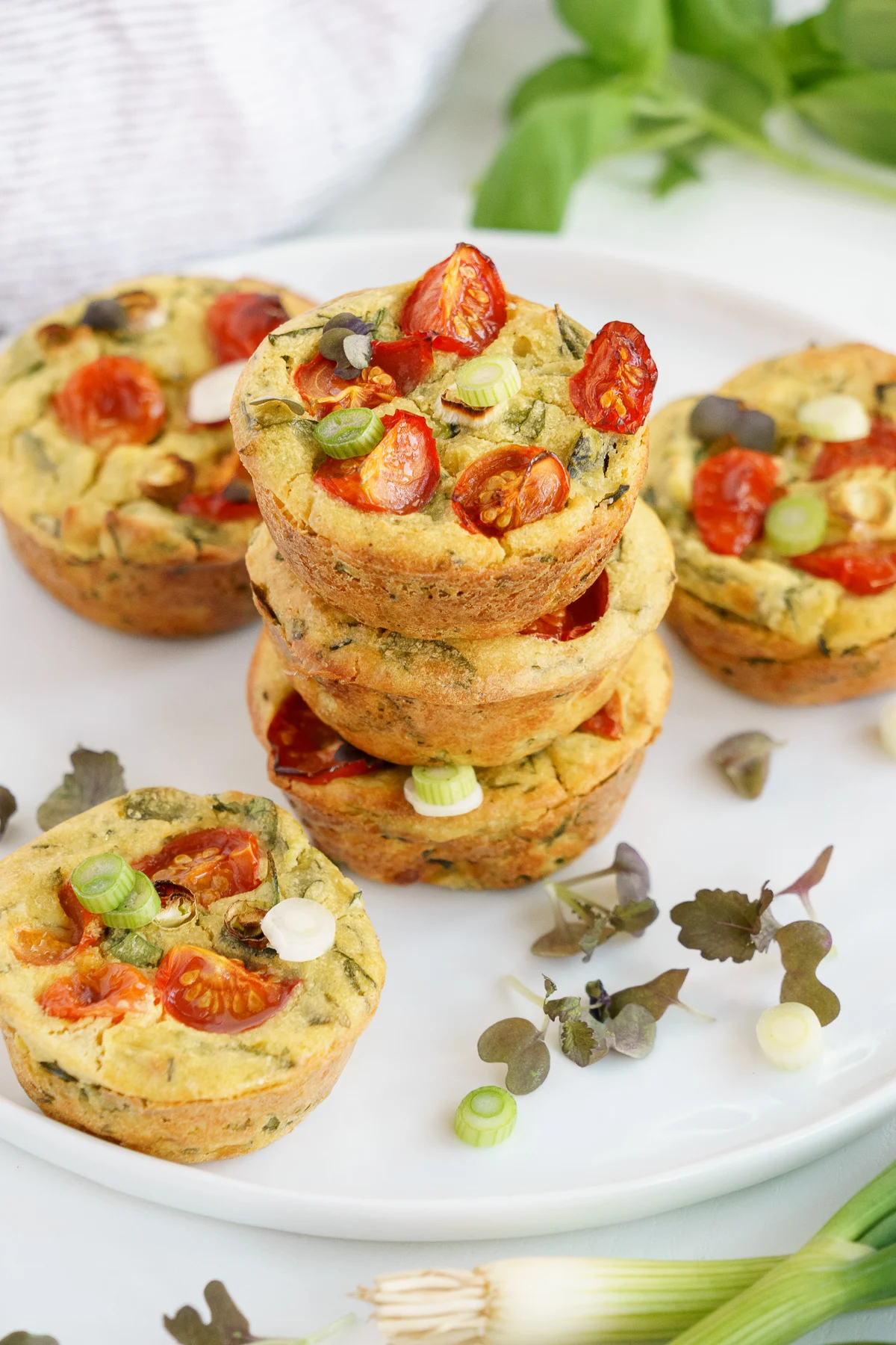 Vegan egg muffins topped with veggies and herbs