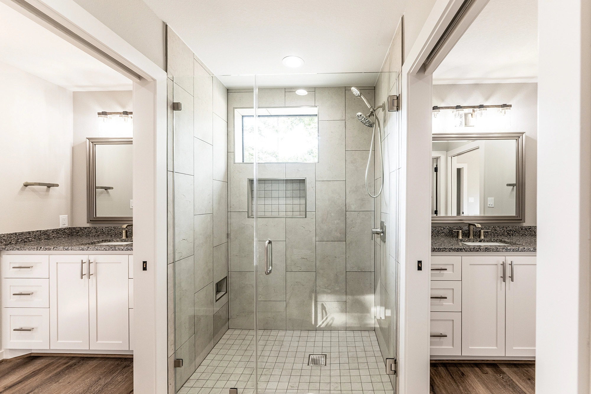 A modern bathroom featuring two vanity rooms