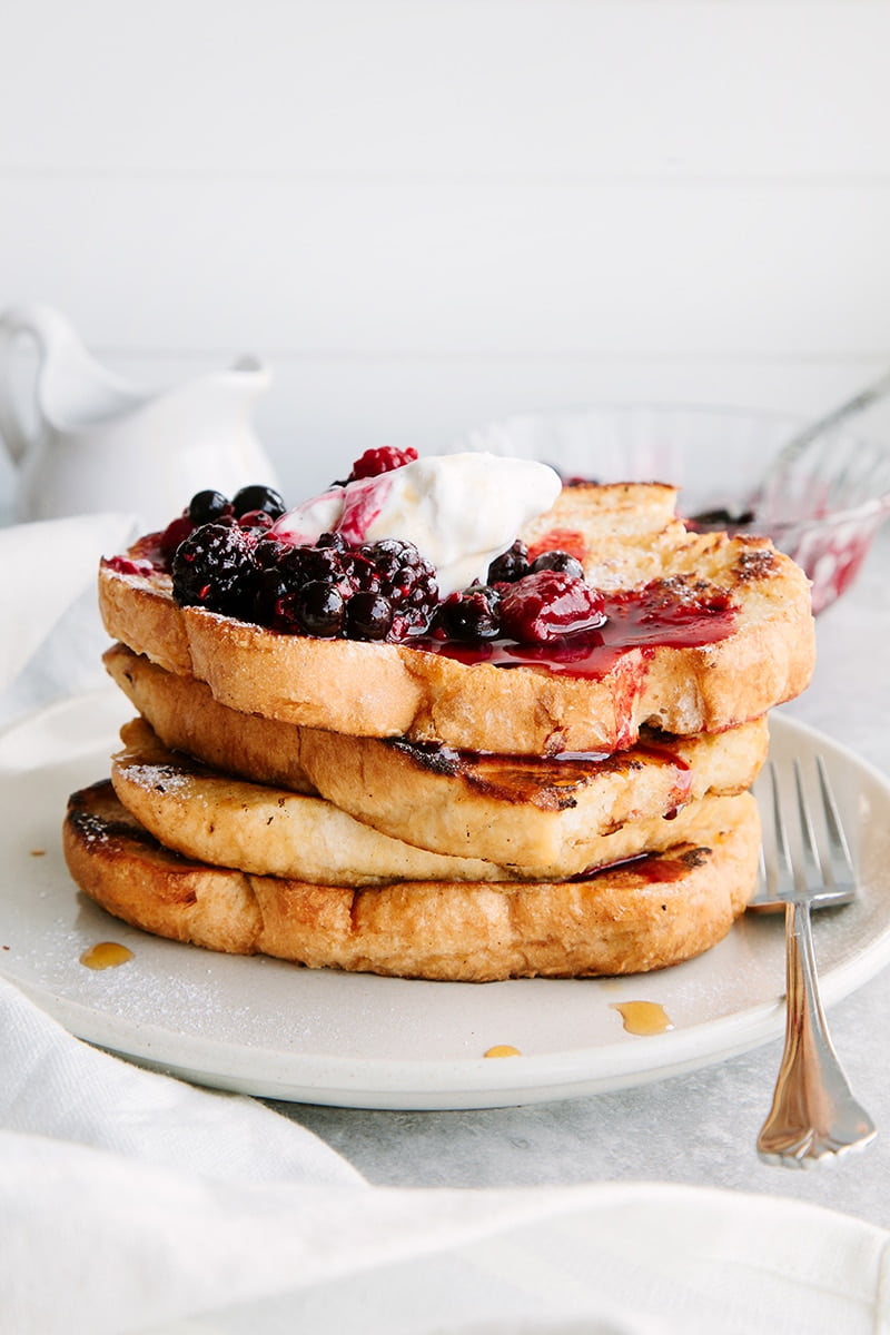 Slices of french toast with berries and whipped cream