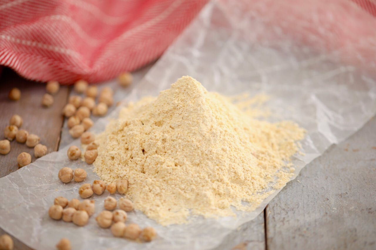 A pile of chickpea flour or garbanzo bean flour sits on a table