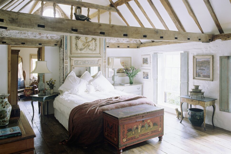 A barndonimium interior bedroom with wood beams and stone walls