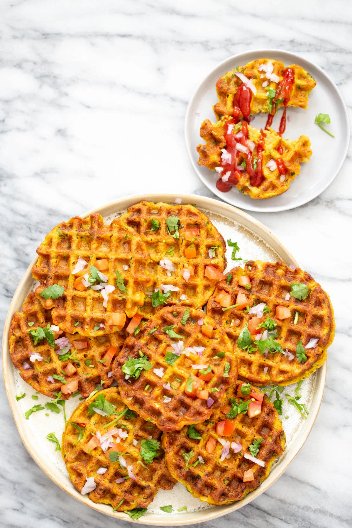 Savory waffles are topped with herbs, onions and tomotoes