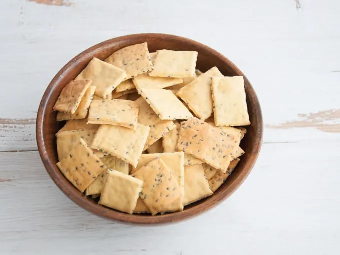 A bowl of homemade gluten free chickpea crackers made from garbanzo bean flour